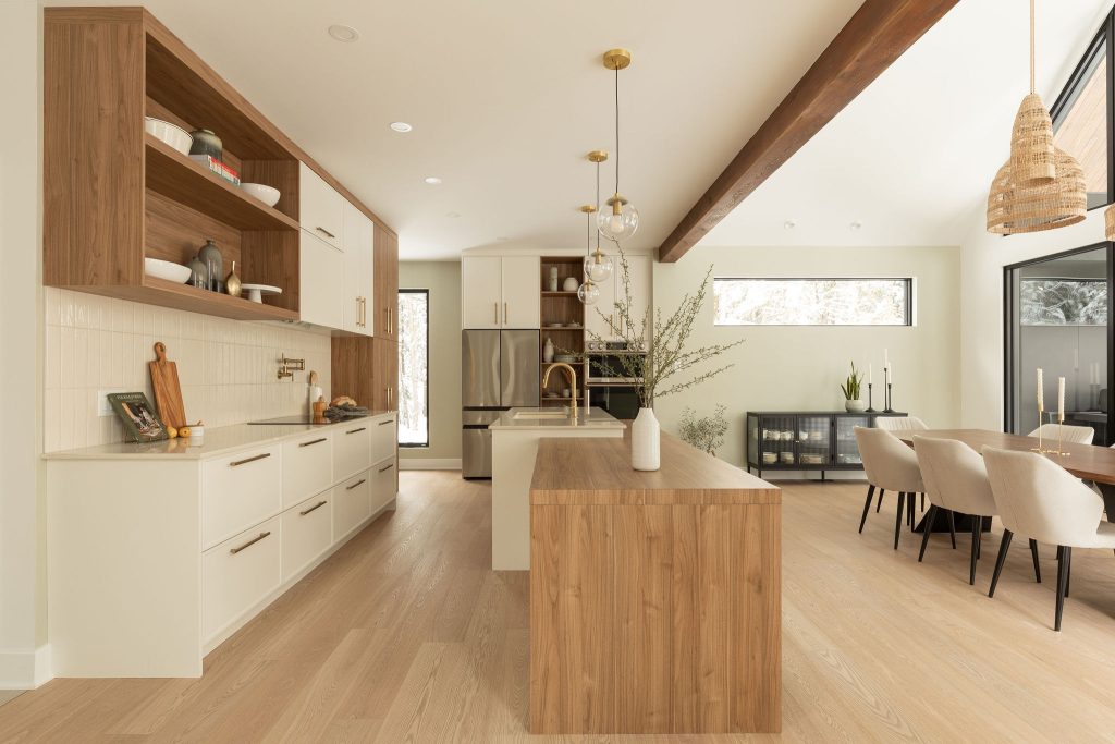 Bright open-concept kitchen with natural wood and gold accents.