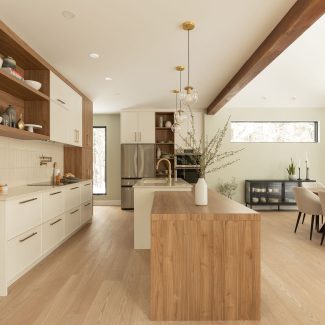 Bright open-concept kitchen with natural wood and gold accents.