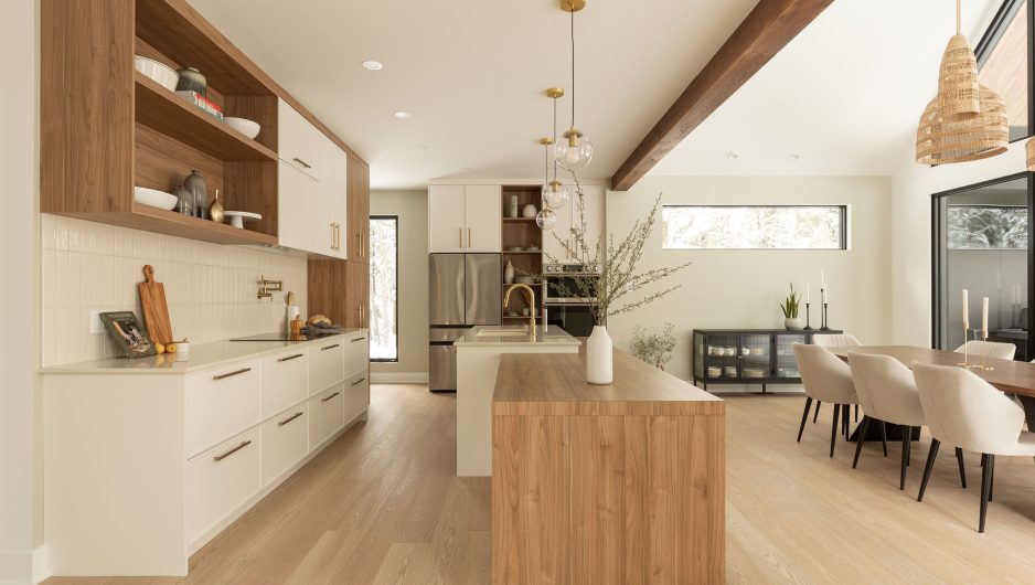 Bright open-concept kitchen with natural wood and gold accents.